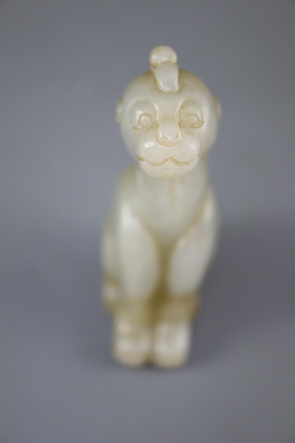 A Chinese pale celadon and russet jade figure of a mythical beast, 7.5cm high